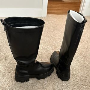 Knee high black boots.